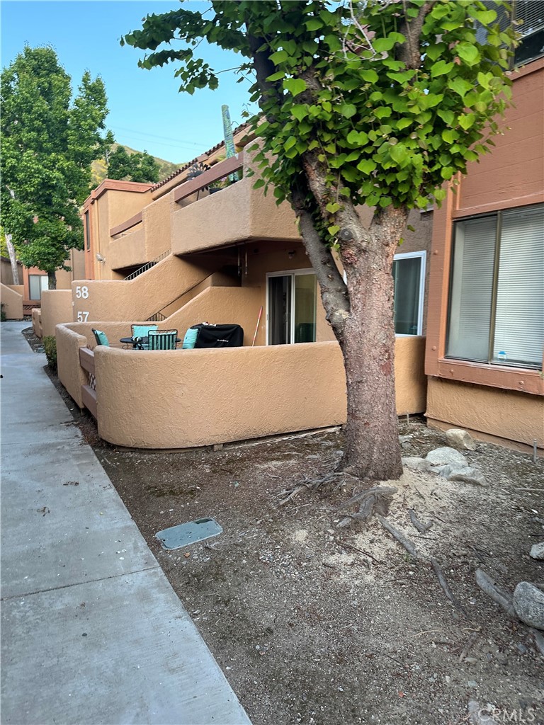 1440 West Edgehill Road, Unit 57 San Bernardino, CA 92405 - Photo 1 of 1 a view of a house with a tub and large tree