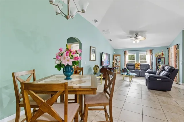a living room with furniture and flowers