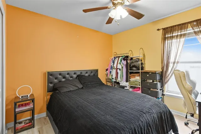 a bedroom with a bed and a chandelier