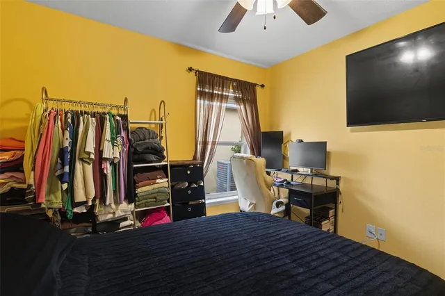 a view of a workspace with furniture and a flat screen tv