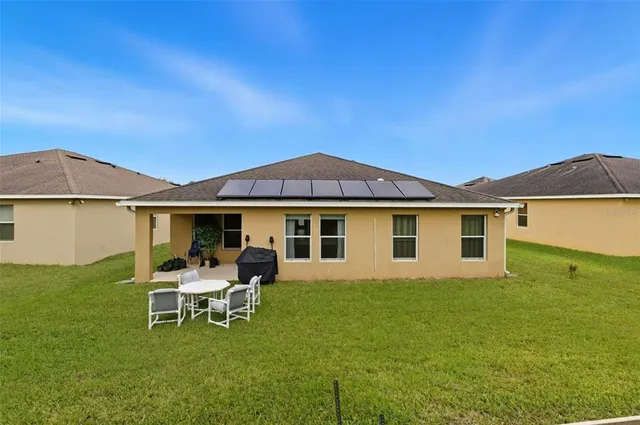 a white house with a yard and sitting area