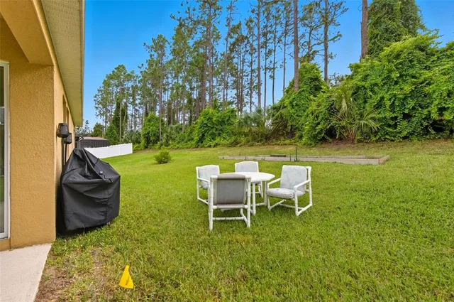 a backyard of a house with table and chairs