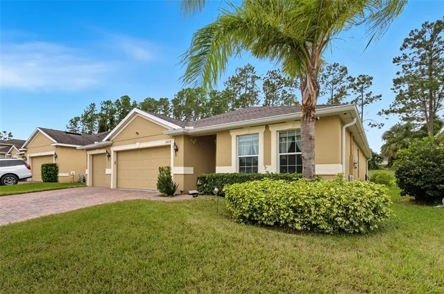 a view of a house with a yard and garage