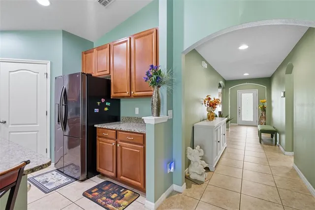 a kitchen with refrigerator and cabinets