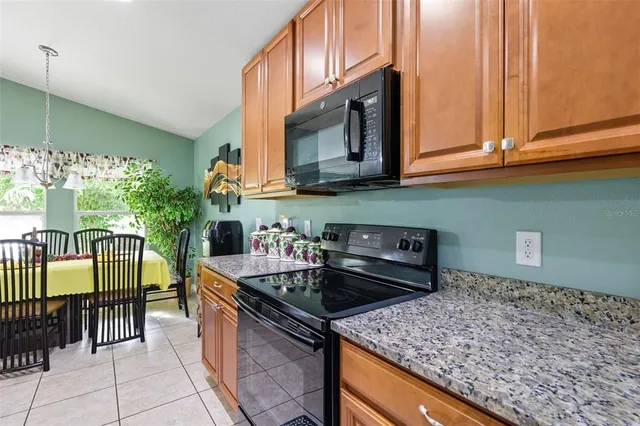 a kitchen with stainless steel appliances granite countertop a stove and a microwave