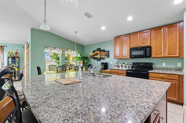 a kitchen with a stove a sink and a microwave