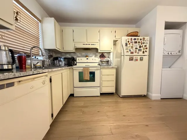 a kitchen with stainless steel appliances a refrigerator sink and cabinets
