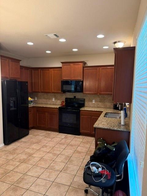 5412 Tama Drive Waco, TX 76708 - Photo 15 of 24 a kitchen with granite countertop a refrigerator stove and wooden cabinets