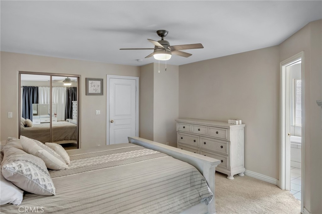 14952 Rivers Edge Road Helendale, CA 92342 - Photo 25 of 33 a bedroom with a bed and a chandelier