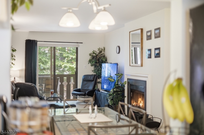 609 Mark Twain Way Mahwah, NJ 07430 - Photo 4 of 40 a living room with furniture a chandelier and a fireplace