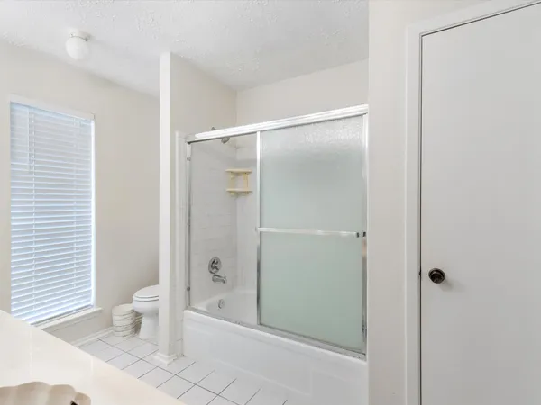 a bathroom with a shower and a toilet