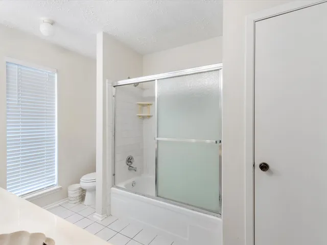 a bathroom with a shower and a toilet
