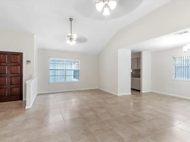 an empty room with windows and cabinet