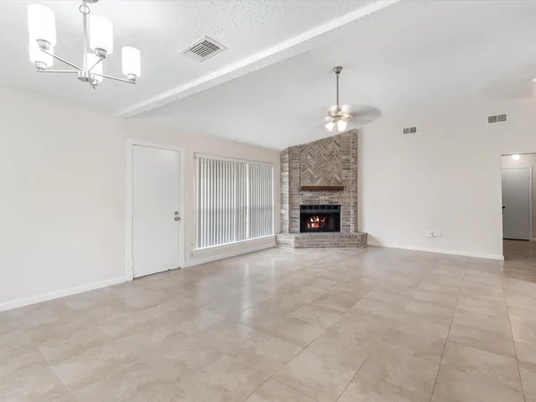 a view of an empty room with a fireplace