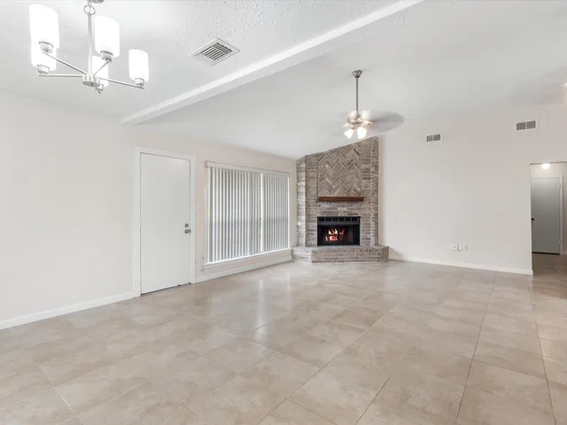 a view of an empty room with a fireplace