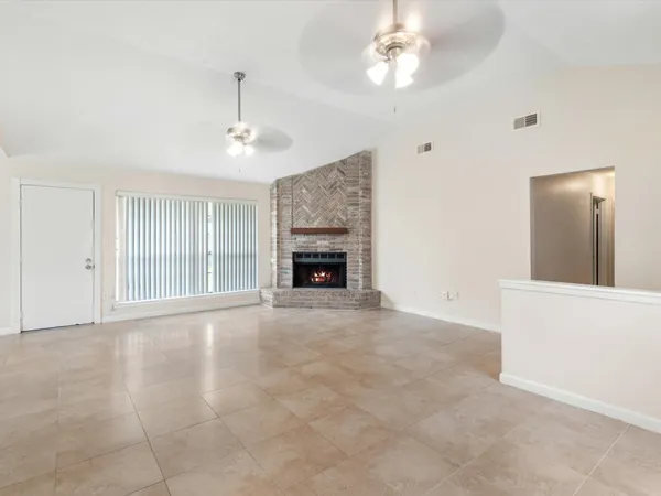 a view of an empty room with a fireplace