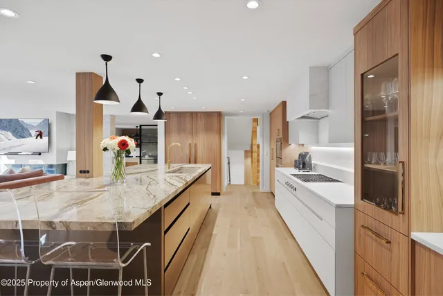 a kitchen with kitchen island granite countertop a sink stove and refrigerator