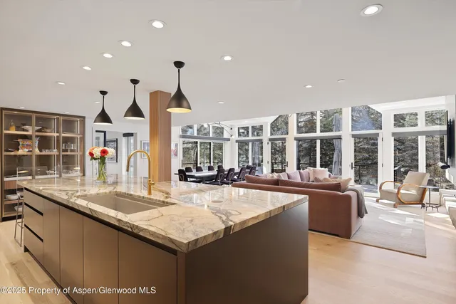 a kitchen with stainless steel appliances granite countertop a sink and a large window