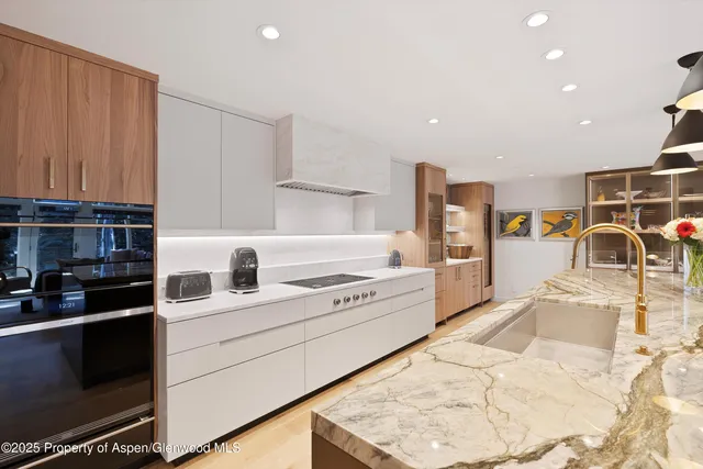 a kitchen with a sink stove and cabinets