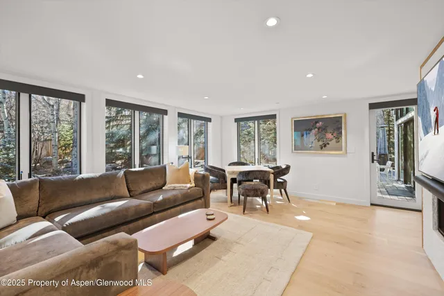 a living room with furniture and large windows