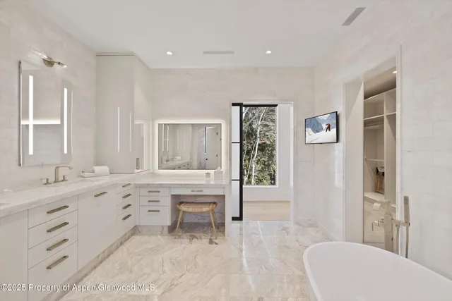 a spacious bathroom with a sink mirror and a bath tub