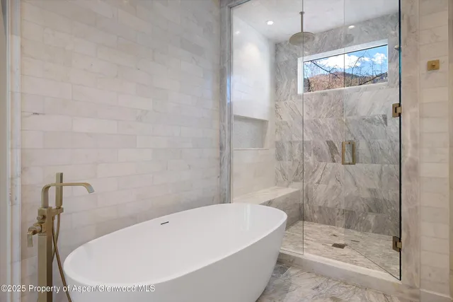 a bathroom with a white bath tub and shower
