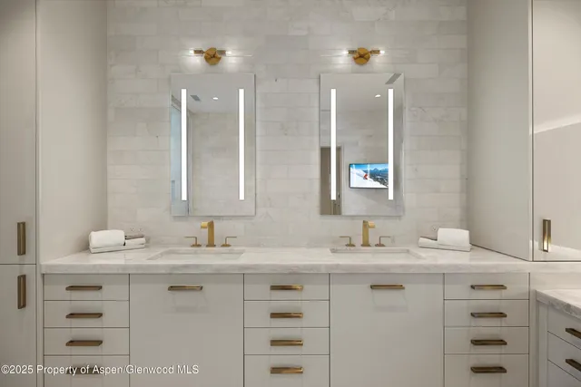 a bathroom with a sink double vanity and a mirror