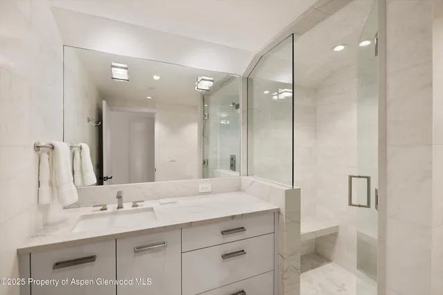 a bathroom with a granite countertop sink mirror and double