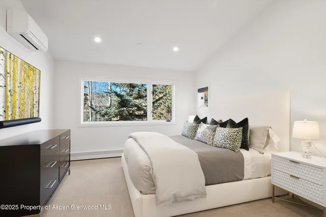 a bedroom with a large bed and a large window