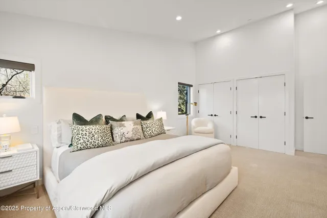 a bedroom with a large bed and a couch