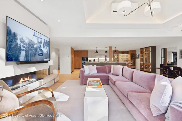 a living room with furniture and view of kitchen