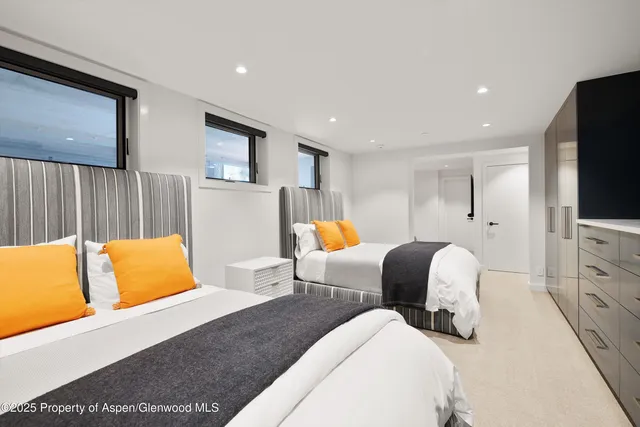 a bedroom with furniture and a flat screen tv