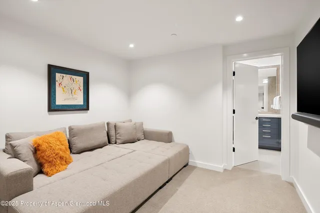 a bedroom with furniture and a flat screen tv