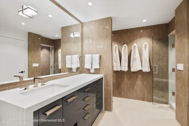 a bathroom with a sink double vanity and a shower