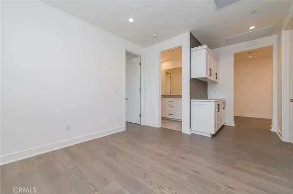 a view of a kitchen with white cabinets