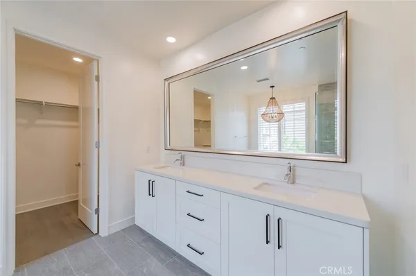 a bathroom with a double vanity sink and mirror