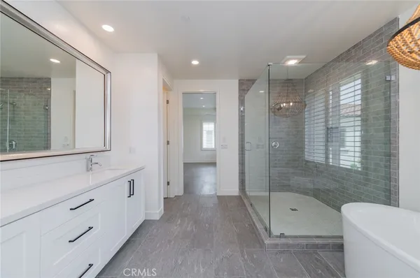 a bathroom with a double vanity sink toilet and shower