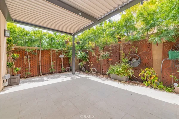 a backyard of a house with a garden and outdoor seating
