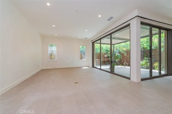 a view of an empty room with windows and balcony