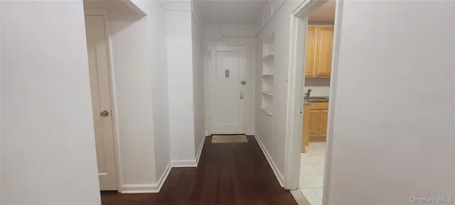 a view of a hallway with a wooden floor