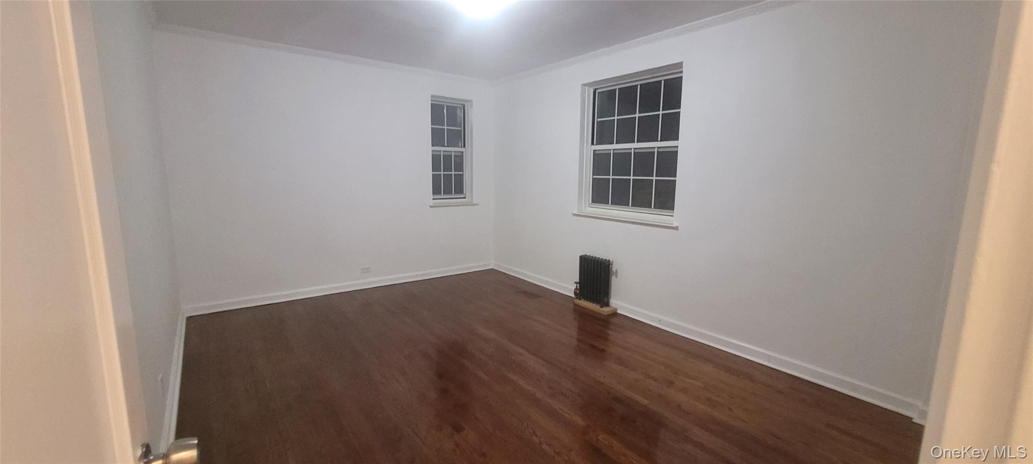 77-04 141st Street, Unit 67F Queens, NY 11367 - Photo 4 of 11 an empty room with windows