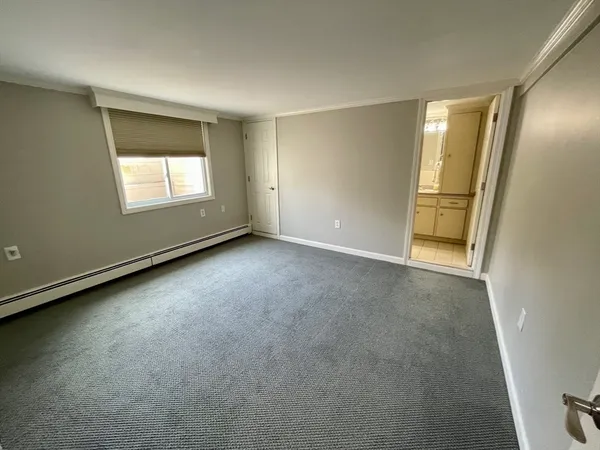 a bedroom with a bed couch and window