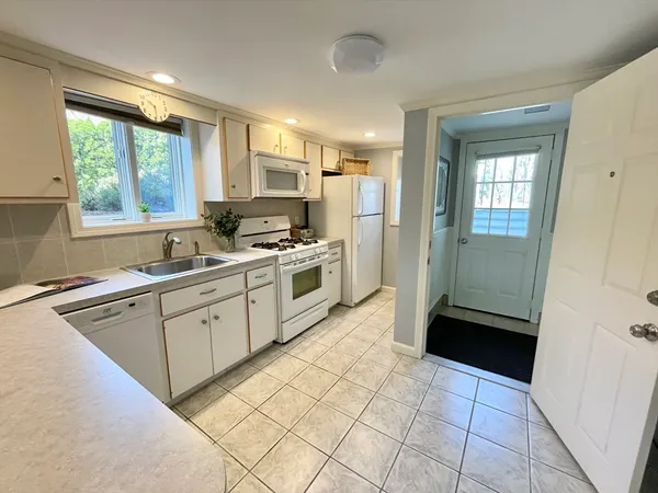 a kitchen with a refrigerator a sink and a window