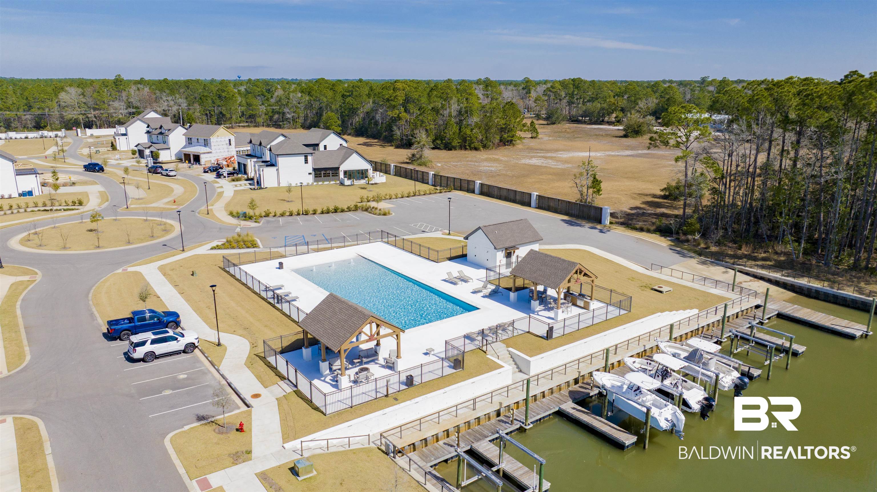 861 Inlet Circle Gulf Shores, AL 36542 - Photo 47 of 54 Aerial view of a pool area and a tree filled landscape