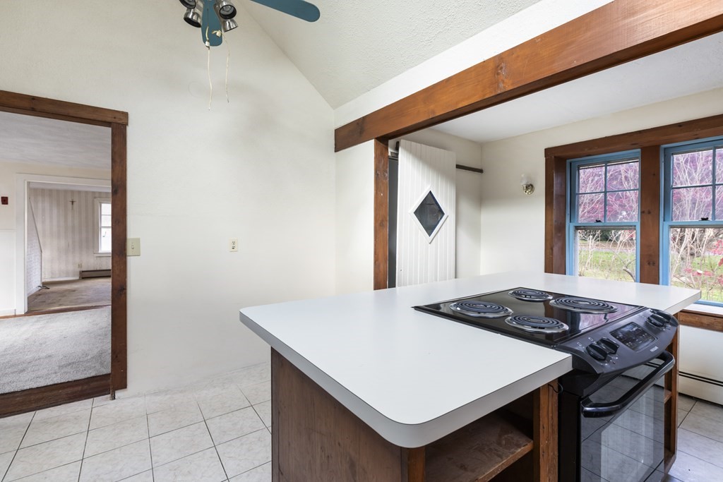 103 Myrtle Street Ashland, MA 01721 - Photo 11 of 38 a kitchen that has a stove and a table