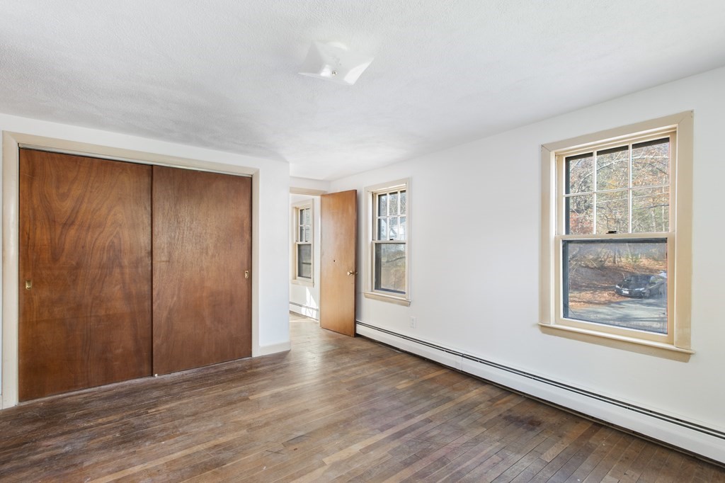 103 Myrtle Street Ashland, MA 01721 - Photo 18 of 38 a view of an empty room with wooden floor and a window