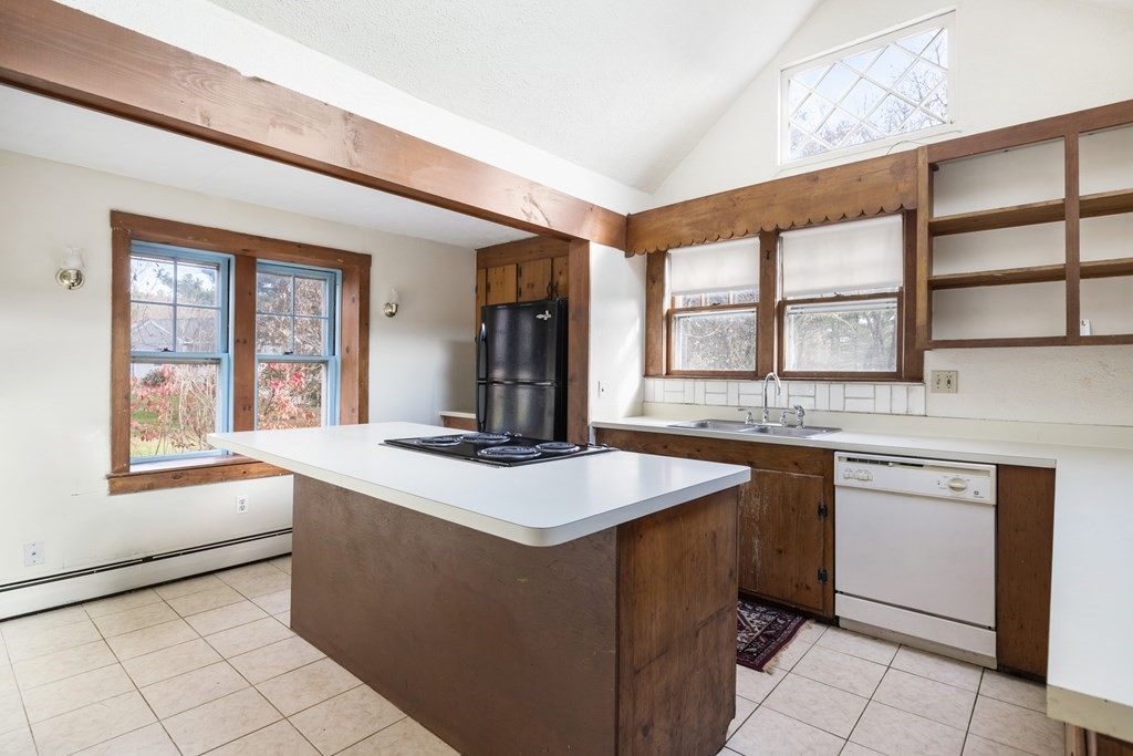 103 Myrtle Street Ashland, MA 01721 - Photo 9 of 38 a kitchen with stainless steel appliances granite countertop a sink and a stove