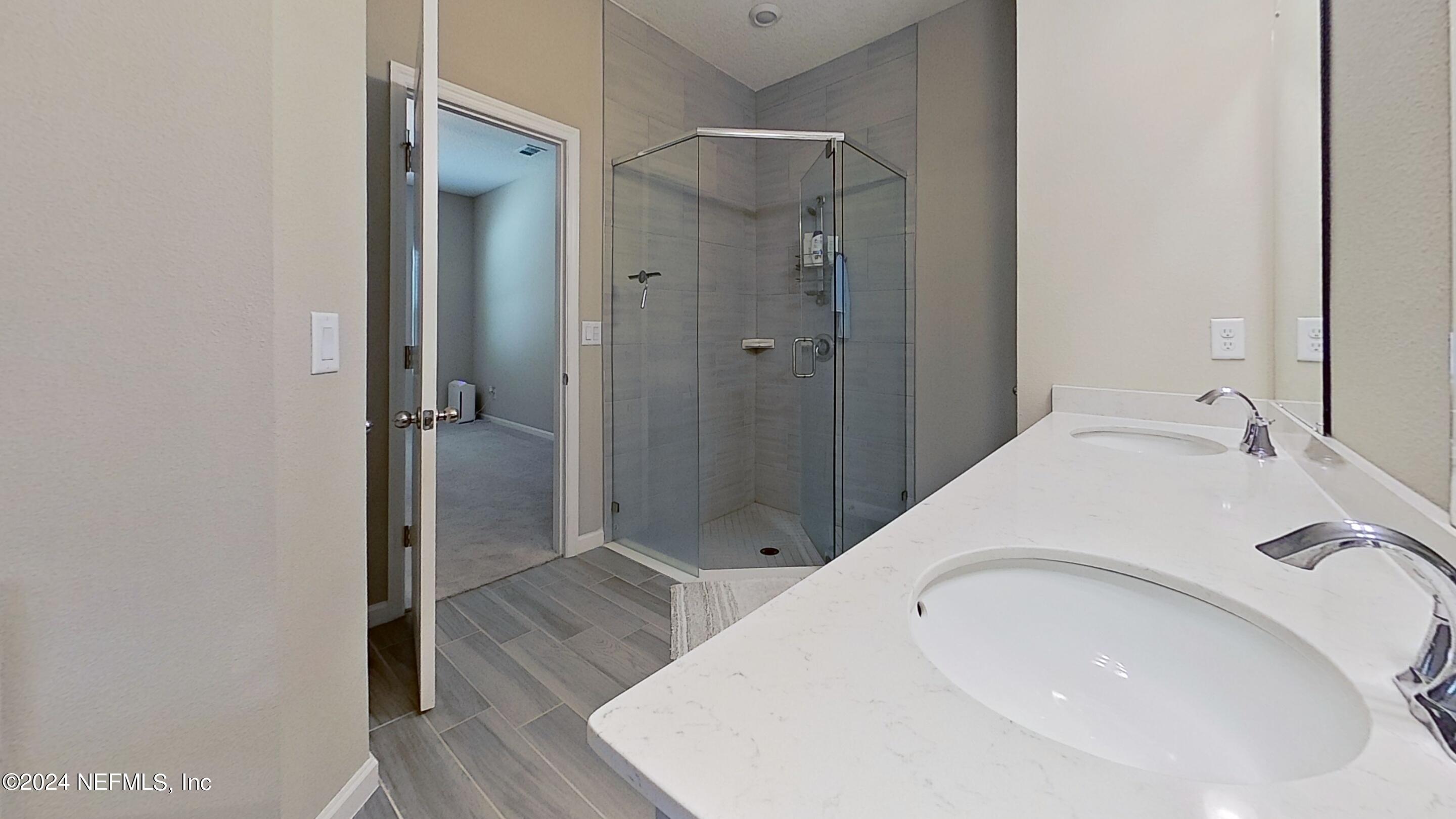 10887 Ventnor Avenue Jacksonville, FL 32218 - Photo 11 of 19 a bathroom with a sink and shower