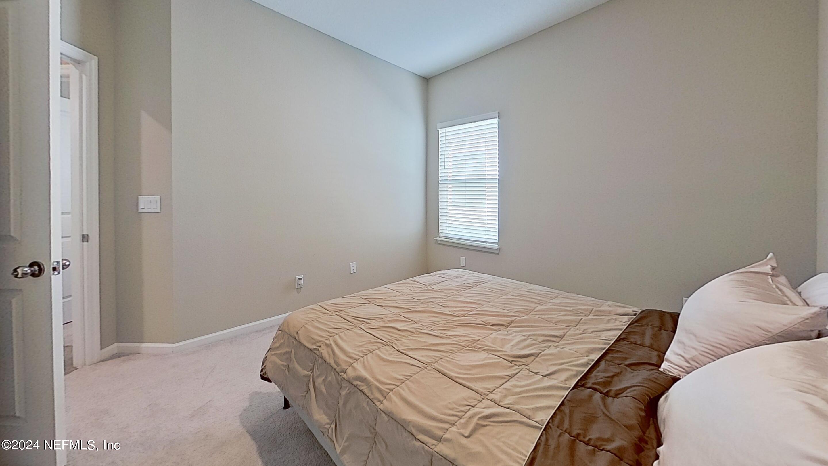 10887 Ventnor Avenue Jacksonville, FL 32218 - Photo 12 of 19 a bedroom with a bed and a window