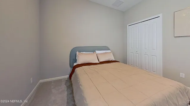 a bedroom with a bed and a wall painting